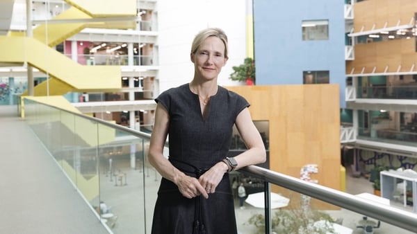 Photo of Antigone Davis, Global Head of Safety, at Meta standing on a balcony in an office building