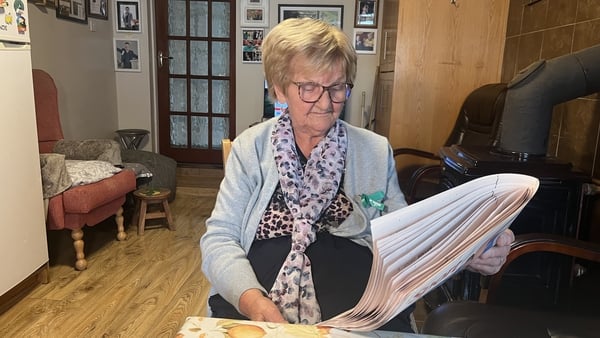 Emily Scanlon grandmother of shane lowry reading a newspaper in her home