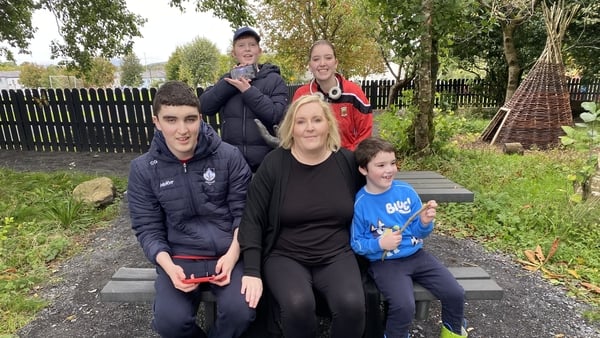 People sit on a bench in a park