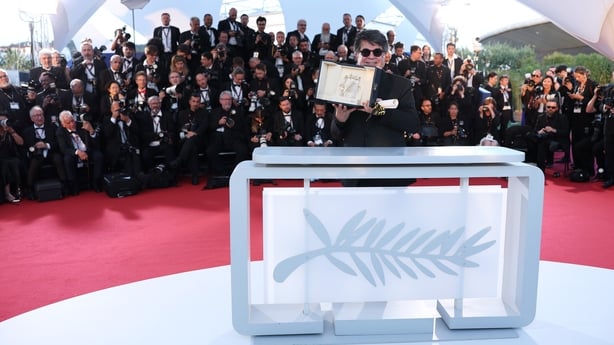 Jafar Panahi poses with the Palme d'Or award for It Was Just an Accident at the 78th annual Cannes Film Festival at Palais des Festivals on 24 May, 2025 in Cannes