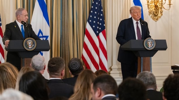 Benjamin Netanyahu looks at Donald Trump as he speaks at a press conference in the White House
