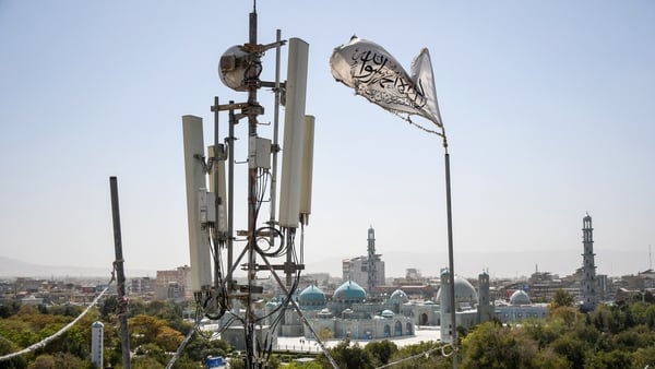 Telecoms tower beside Taliban flag in Afghanistan
