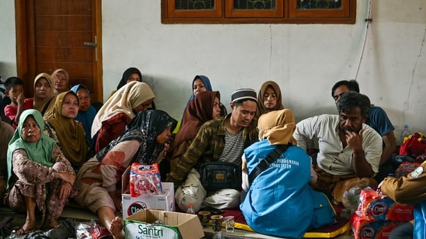 Relatives of unaccounted students gather as search and rescue operations continue at the Al Khoziny Islamic boarding school in Sidoarjo, East Java province after a multistorey building at the school collapsed,