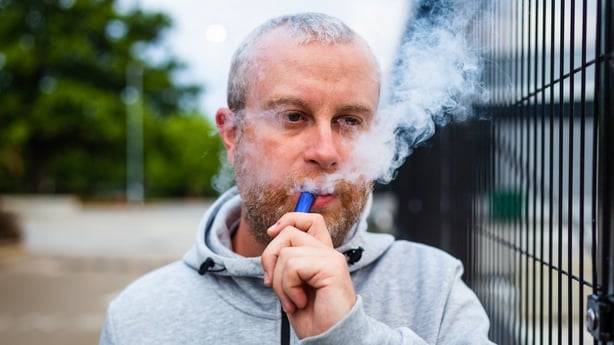 man in his 30s vaping 