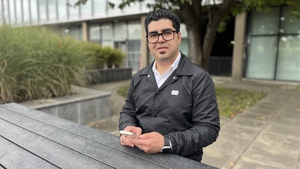 A picture of Sayed Farid Sanai sitting at a table outside