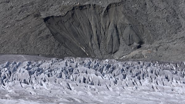 Seracs point upward from a portion of the Aletsch Glacier under a collapsing moraine in Switzerland