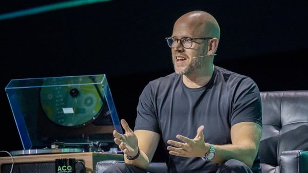 Man dressed in casual clothes addresses a tech conference