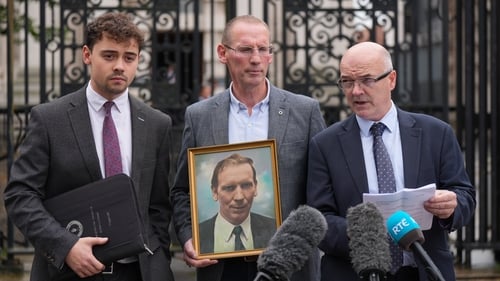 Ferghal Kelly (C), the son of the late Cllr Patsy Kelly, at Belfast high court with his solicitors Darragh O'Kane (L) and Adrian O'Kane