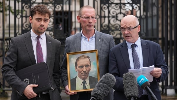 Ferghal Kelly, the son of the late Cllr. Patsy Kelly, (centre) at Belfast high court with his solicitors Darragh O'Kane (left) and Adrian O'Kane (right)