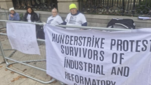 Protesters sit outside Dáil Eireann while on hunger strike
