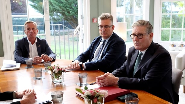 British Prime Minister Keir Starmer sits alongside Jakob Baruel Poulsen, CEO of CIP