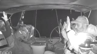 Photo shows flotilla crew members holding their hands up