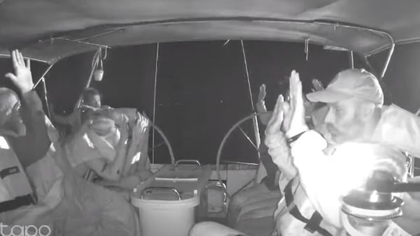 Photo shows flotilla crew members holding their hands up