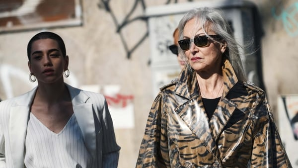 Two women photographed walking on the street