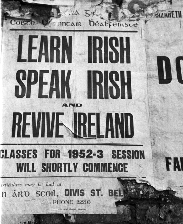 20th February 1954: A poster advertising lessons in the Irish language on a wall in Belfast, Northern Ireland. Original Publication: Picture Post - 7029 - The Best And The Worst Of Some British Cities 5 - Belfast - pub. 1954 (Photo by John Chillingworth/Picture Post/Hulton Archive/Getty Images)