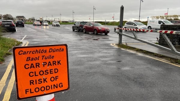 A sign reads 'Car Park Closed Risk of Flooding' at a car park in Galway