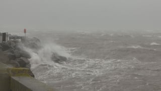Waves crash into Fenit Pier