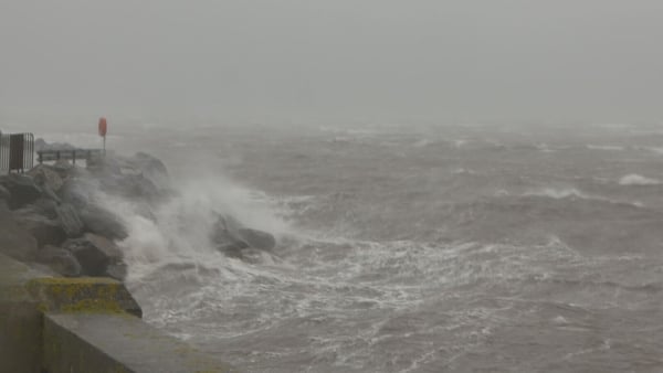 Waves crash into Fenit Pier