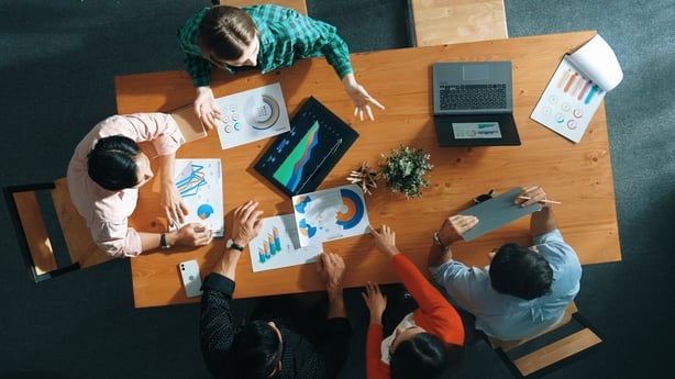 Top down view of business woman explaining and present financial chart