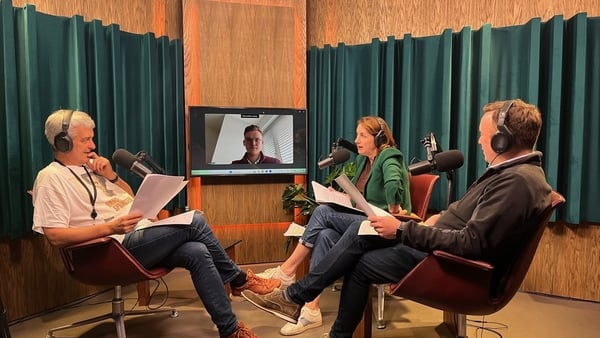 Podcast team sitting discussing the latest topics