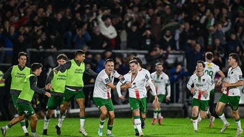 Evan McLaughlin of Cork City (C) is mobbed after scoring his side's third goal