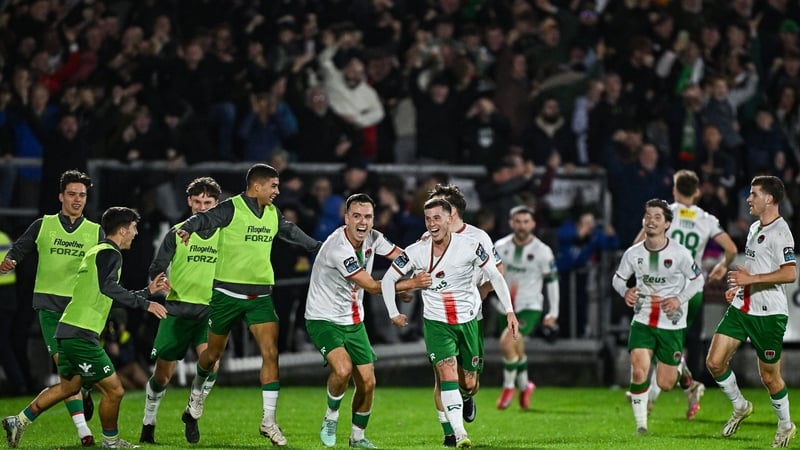 Evan McLaughlin of Cork City (C) is mobbed after scoring his side's third goal