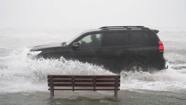 A car drives through floodwater in Galway