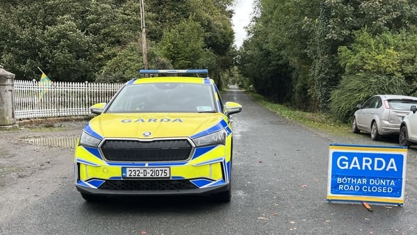 a garda car and a garda sign indicating an incident and road closure