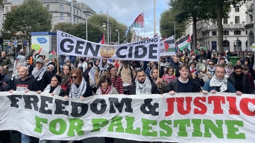 Participants including left-wing political groups and trade unions held banners and waved Palestinian flags