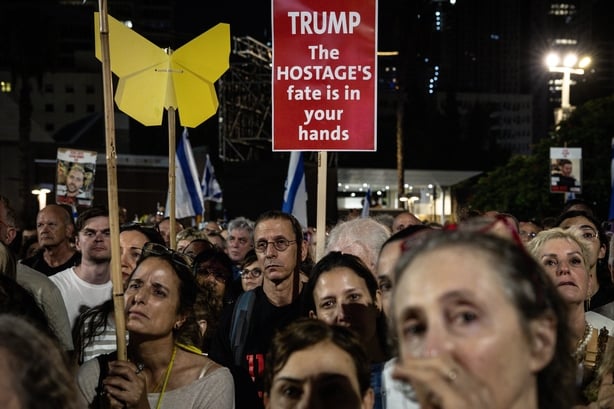 People chant slogans and hold placards
