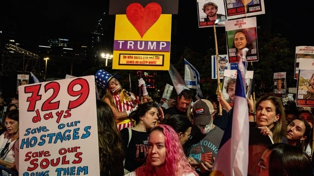 People chant slogans and hold placards