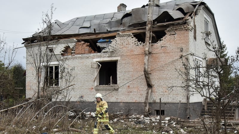 A rescue worker is seen in front of a badly damaged building in Lapaivka, Lviv region following overnight Russian attacks