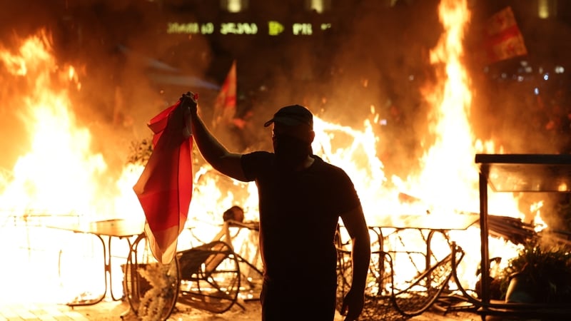 Protesters burn barricades as they clash with police during an opposition rally on the day of local elections in central Tbilisi yesterday