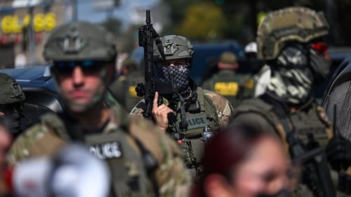 Federal Agents watch as demonstrators protest in Chicago as federal agents were investigating a shooting