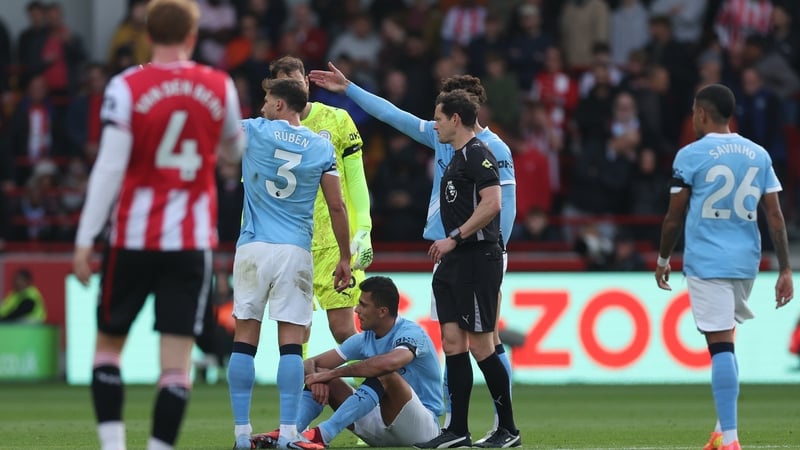 Rodri (sitting) was forced off injured against Brentford