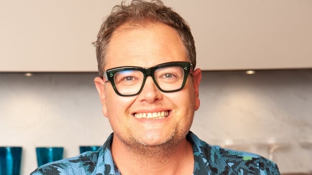 Alan Carr smiles to camera