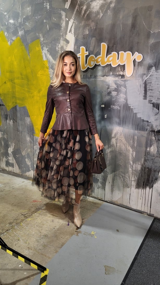Model wearing a dress and jacket
