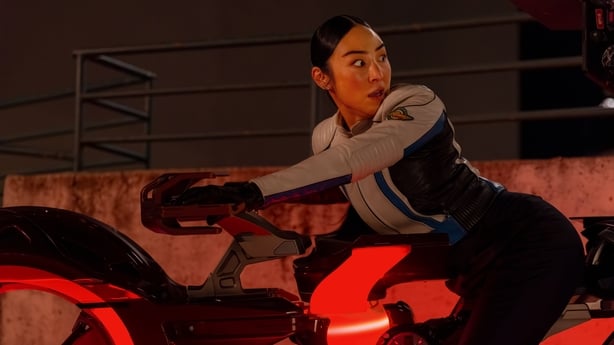Greta Lee as Eve Kim tries to evade capture in Tron: Ares Photo by Leah Gallo