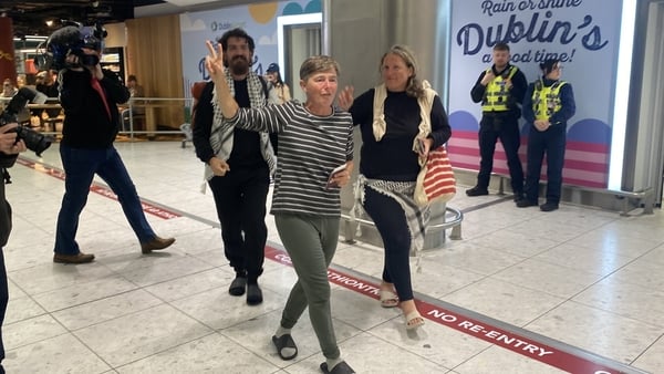 Thomas McCune, Sarah Clancy and Donna Schwartz were welcomed at the airport by family, friends and supporters.