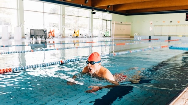 older man swimming in a pool