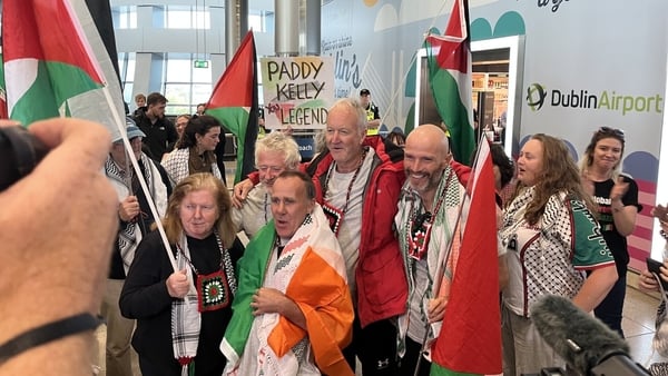 A group of Irish citizens arrive home at Dublin Airport after being held by Israel