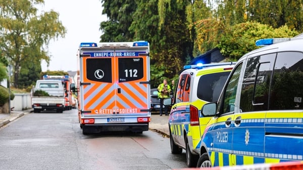 An ambulance and police cars are seen near the site where Iris Stalzer, the newly elected mayor of Herdecke, western Germany, was severely injured in a knife attack