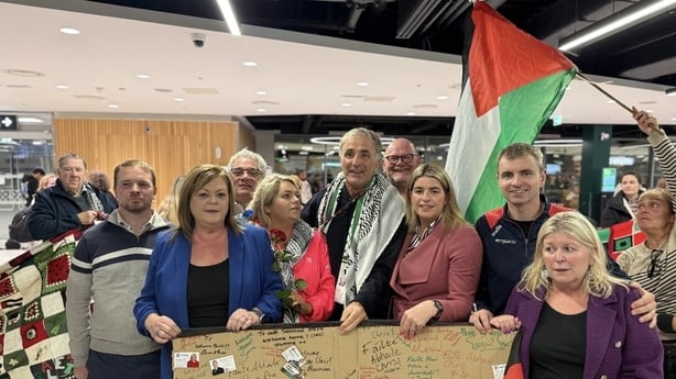 Chris Andrews is surrounded by people at Dublin Airport