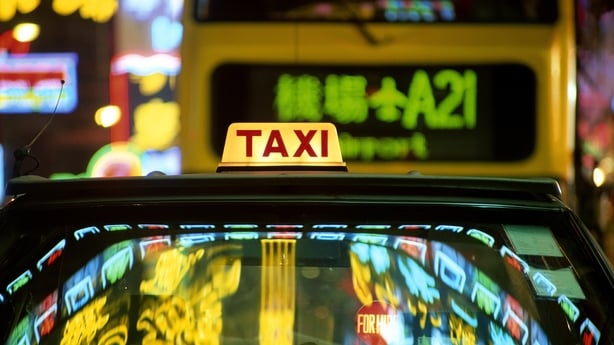 China, Hong Kong, neon signs reflected in taxi at night
