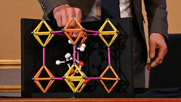 Heiner Linke, Chair of the Nobel Committee for Chemistry, explains a model during a press conference on the winners