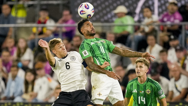 Jamie Reid wins an aerial dual against Germany's Joshua Kimmich in last month's defeat in Cologne