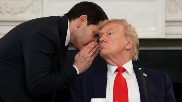 US Secretary of State Marco Rubio speaks to US President Donald Trump during a roundtable discussion in the State Dining Room of the White House