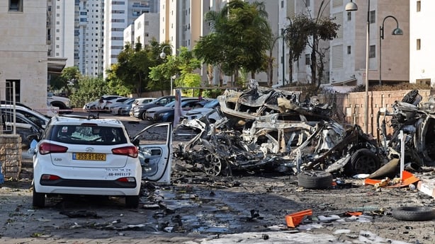 Burnt out vehicles along a street