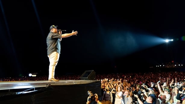 Luke Combs performing onstage at Lollapalooza