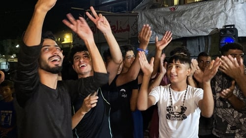Palestinians celebrate in Khan Yunis following news of a new Gaza ceasefire deal
